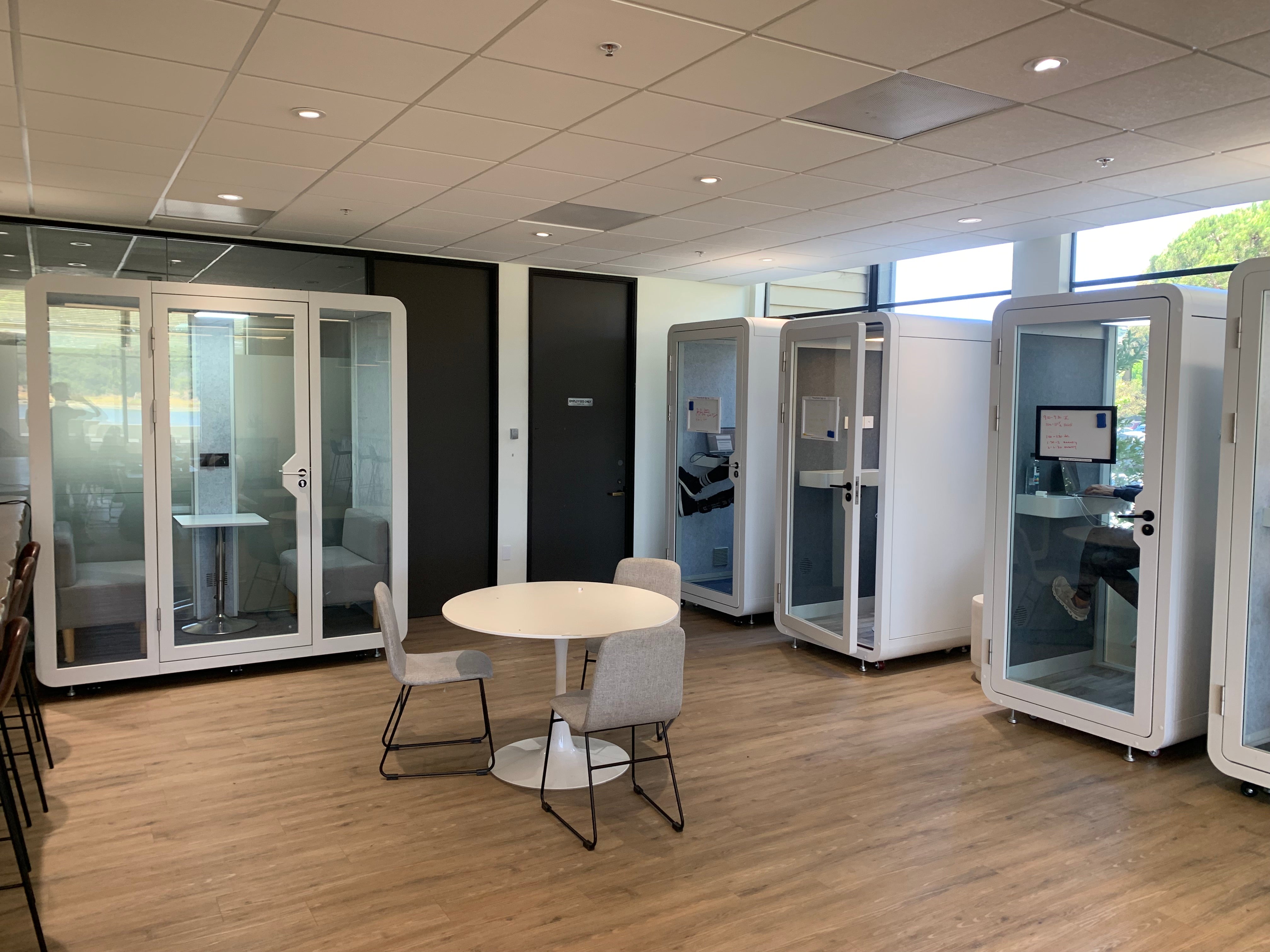 Room full of eBooth privacy booths in a co-working space