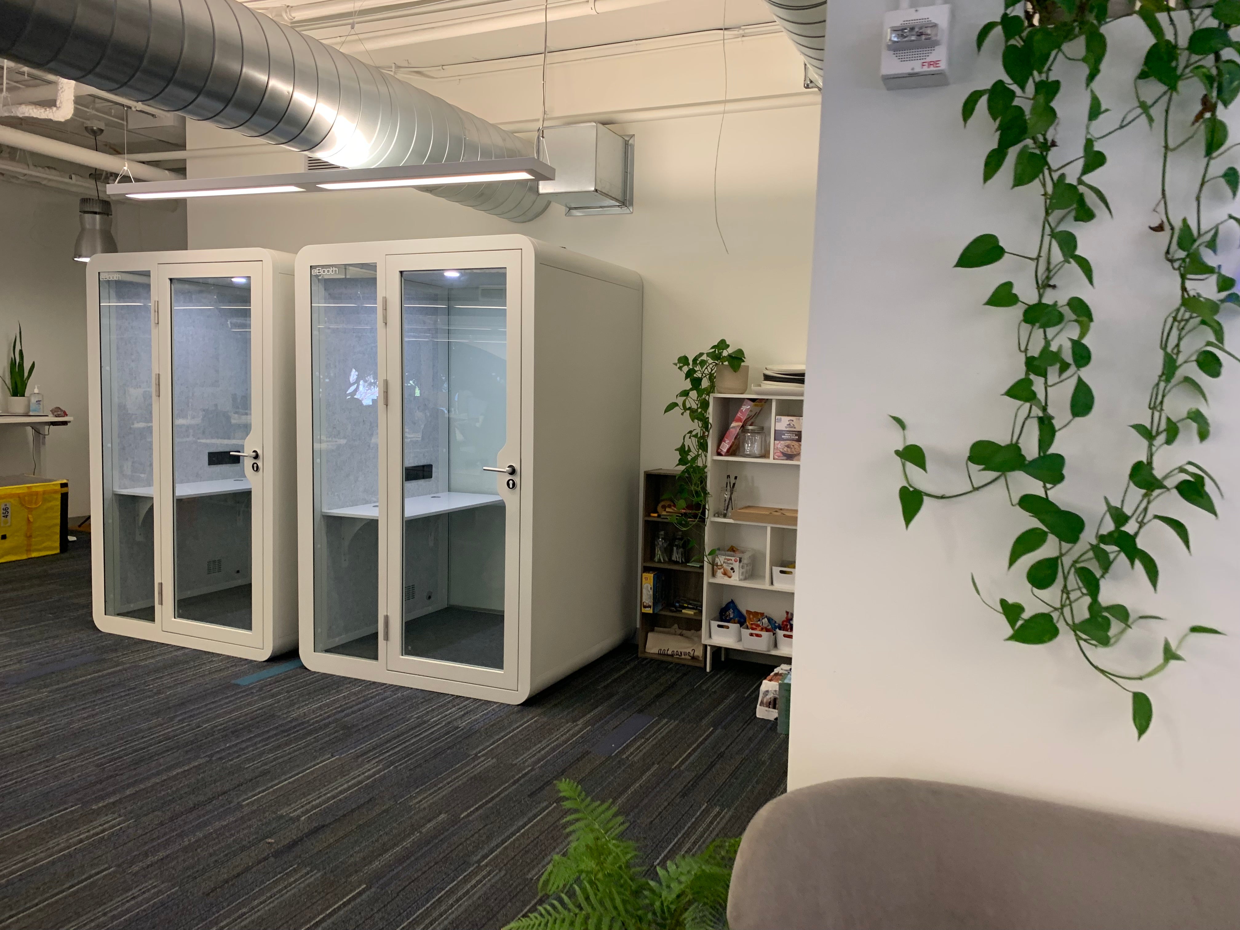 2 eBooth Office model privacy phone booths in a plush office